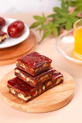 Xinjiang Jujube Nut Bars Traditional Chinese Sweet Snacks on Wooden Board with Tea Time Setup