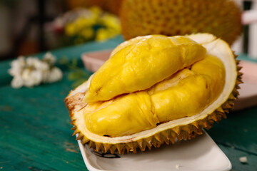 Fresh Golden Durian Fruit with Creamy Flesh Displayed in Spiky Shell at Tropical Market