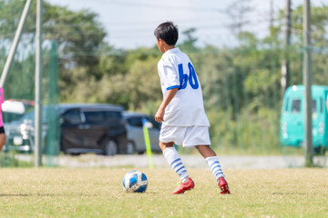 サッカーの試合をする中学生の男の子