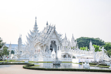Fototapeta premium Wat Rong Khun, or the White Temple, is a Buddhist temple located in Chiang Rai, Thailand. The temple attracts many tourists. The White Temple was built by Chalermchai Kositpipat, who also designed