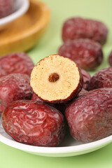 Xinjiang Red Jujube Dates Cut in Half Showing Interior on White Plate - Chinese Dried Fruit
