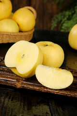 Fresh Yellow Apples Sliced on Rustic Wood Table with Basket - Yantai Organic Fruit