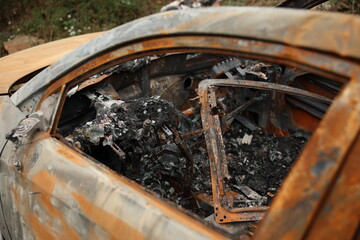 Abandoned Burnt Car Wreck on Mountain Roadside