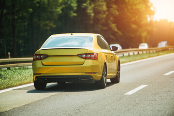Car speeding on forest highway view