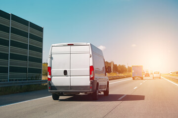 Cargo van traveling on clear highway © AlexGo