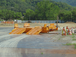 A base for a cement truck installed at the entrance of the construction site.