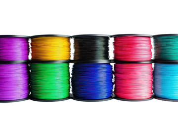 Colorful stack of printing filament rolls in various shades arranged neatly against a white backdrop