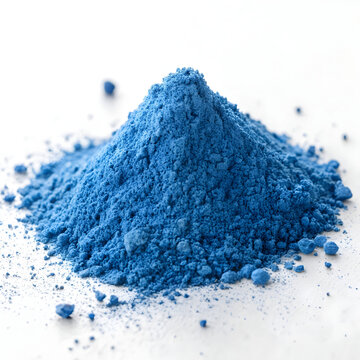 A striking blue heap of spirulina powder sits on a clean white background, highlighting its vivid color