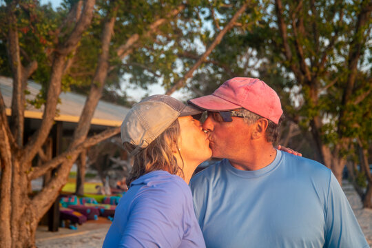 Active Seniors embrace Paddleboarding  at sunset