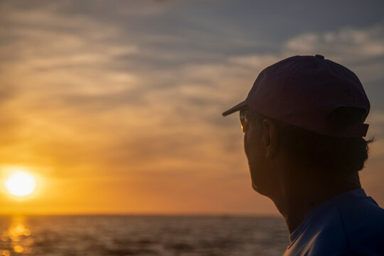 Active Seniors embrace Paddleboarding  at sunset