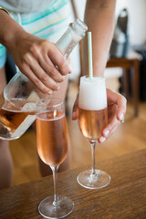 Pouring Rosé Champagne into Flutes