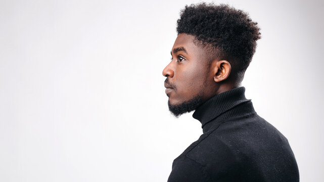 Side portrait of handsome young man looking away while posing