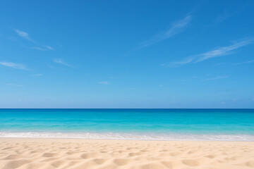 Fototapeta premium A peaceful tropical beach scene featuring soft golden sand, gentle turquoise waves, and a clear blue sky with light clouds.
