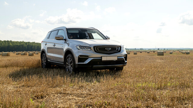 Moscow, Russia, August 24, 2025:Geely Atlas pro car on a field with hay circles