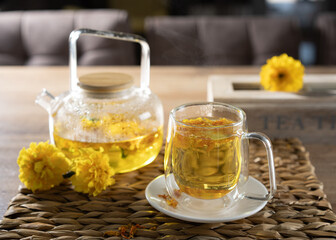 Relaxing afternoon with herbal tea and flowers on wooden table in cozy setting