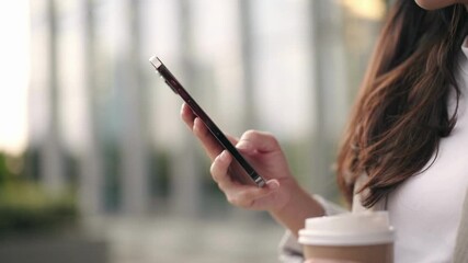 Close up side view millennial woman holding cellphone in social media networks in blurred light background Technology concept - Powered by Adobe