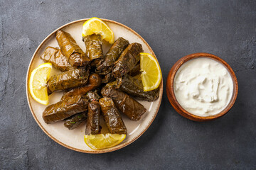 Delicious Turkish dish, stuffed vine leaves, on a black stone table