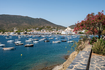 White boats are floating peacefully in the harbor of cadaques, a picturesque town on the costa...