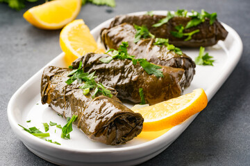 Delicious Turkish dish, stuffed vine leaves, on a black stone table