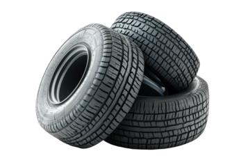 Piled up new tires showcasing distinct tread patterns and rubber composition in a well-lit indoor space for automotive display