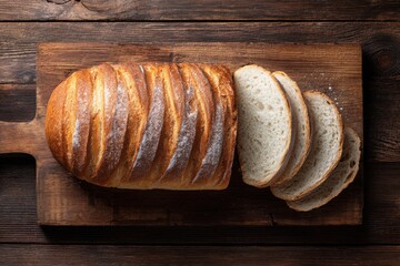 Sliced bread on a dark wooden board with a knife and cloth, ideal for rustic food blogs or bakery menus, or food packaging designs.