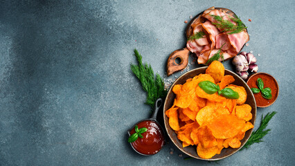 Potato chips with bacon in a ceramic bowl. Salty snacks for beer.