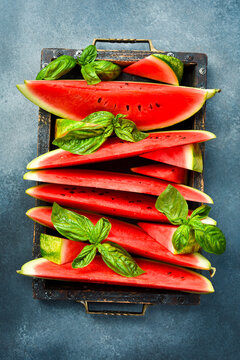 Juicy slices of ripe watermelon in a wooden box. Close-up.