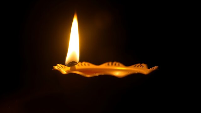 A golden oil lamp glows warmly against a dark backdrop, its flickering flame creating a cozy atmosphere.