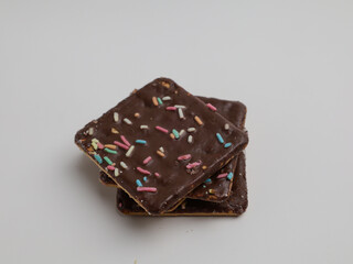 Crunchy crackers coated with chocolate and sprinkles