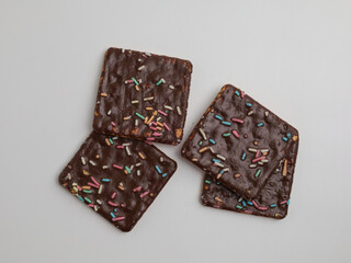 Crunchy crackers coated with chocolate and sprinkles