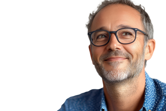 Handsome middle aged man in casual attire smiling warmly with glasses against a neutral background in a relaxed indoor setting