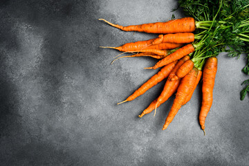 Fresh organic carrots with green leaves. Top view.