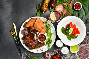 Food background. Fresh kebab, fresh vegetables and Georgian bread in a plate. Top view.