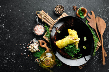 Potato pancake with mushrooms and veal. On a black plate. Ukrainian cuisine. Rustic style.