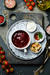 Beet soup. Borscht with veal. Close-up, dark background.