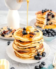 Delicious Blueberry Pancakes Drizzled with Syrup