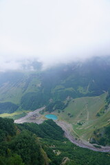 Fototapeta premium A natural landscape with a small blue lake located in the mountains.