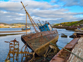 old abandoned sunken ship in the water at the ship cemetery wood pattern