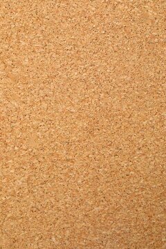 Cork vertical background. Brown yellow color textured cork board background. Natural cork texture. Top view background. High resolution photo. Full depth of field.