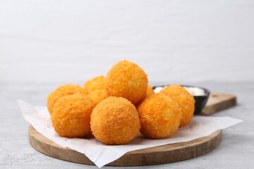 Delicious fried croquette balls on gray table, closeup