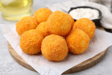 Delicious fried croquette balls on gray table, closeup