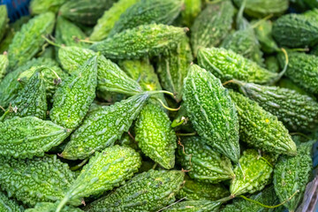 Fresh bitter gourd with a vibrant green texture and natural patterns, symbolizing a healthy food, organic lifestyle, and delicious ingredients for Asian cuisine.