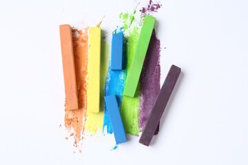 Colorful chalk pastels on white background, flat lay