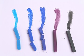 Colorful chalk pastels on white background, flat lay
