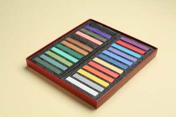 Set of colorful chalk pastels on beige background