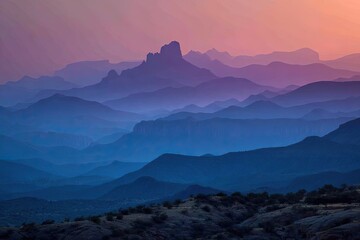 Obraz premium Misty mountain range at sunset, layered in soft hues