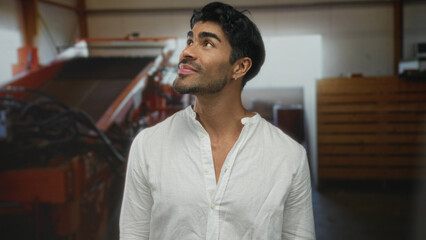 Obraz premium Man with dark hair smiles wearing white linen shirt in building; confidence motivation ambition growth.