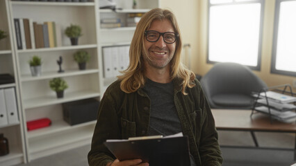 Man adjusts glasses and reads documents on clipboard at office shelves and chair setup under warm lighting; concentration analysis insight.