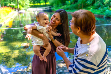 Latin family enjoying time together by the pond