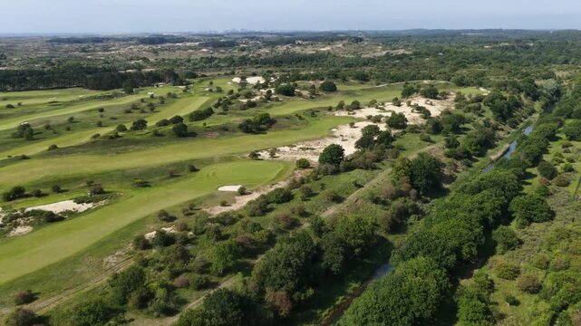 Drone scene of the Kennemer Golf and Country Clubhouse with greens and sand traps in the Netherlands